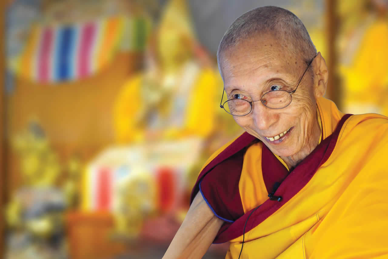 Buddhist Geshla with smile and blured background image